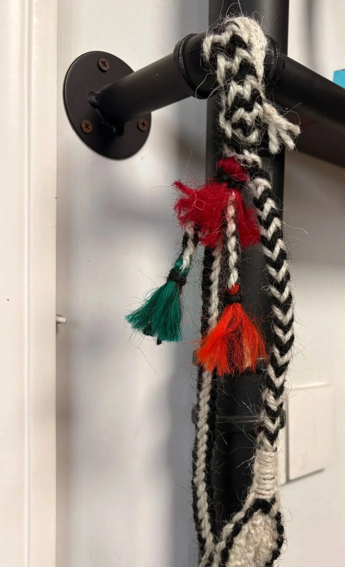 Classic wurdoo sling hanging on a black metal rail